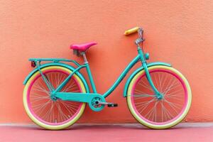 Colorful bicycle against a coral wall photo