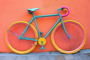 Vibrant bike against a coral wall photo