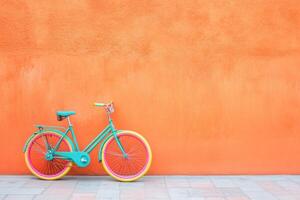 A bicycle is parked against an orange wall photo