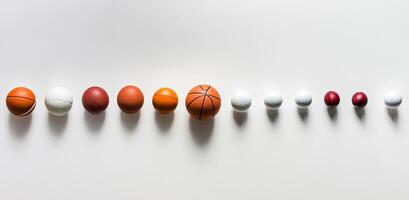 A Row of Sport Balls of Varying Sizes photo