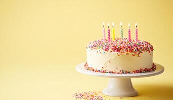 Birthday cake with colorful sprinkles and candles photo