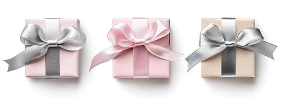 Three gift boxes with pink and silver ribbons photo
