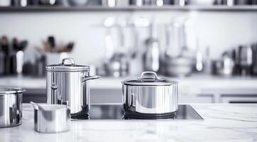 Sleek stainless steel cookware set on a modern kitchen countertop photo