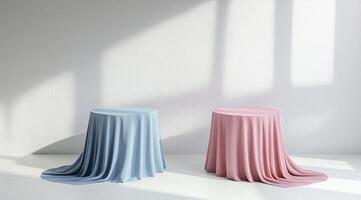 Two draped round display platforms in light pastel colors photo