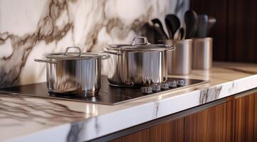 Sleek modern kitchen countertop with stainless steel cookware and marble photo