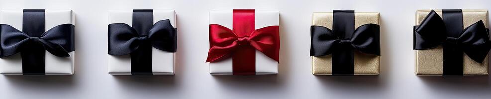 Four gift boxes with black, red and white bows photo