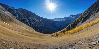 A view of a mountain valley with yellow trees photo