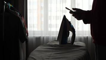 A person is using a cell phone to look at a iron video
