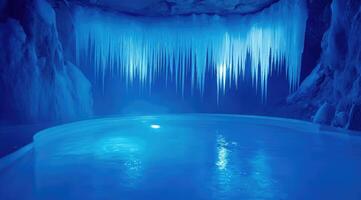 Icy cave pool, illuminated blue photo