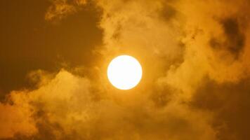 A plane flying through the sky with a sun behind it video