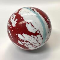 Sphere with swirling red and white patterns and light blue accents photo