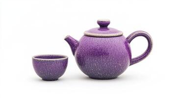 Purple ceramic teapot and cup set photo