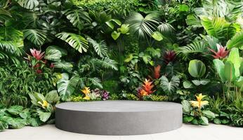 Empty round grey stone podium in lush tropical garden photo