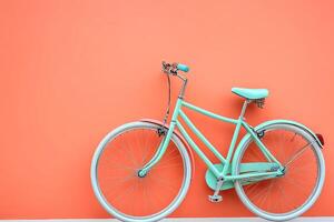 Pastel bicycle against coral wall photo