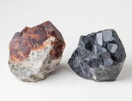 Two raw crystals, one reddish-brown and one black photo