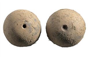 Two ancient, dirty, round, clay balls, likely game pieces or projectiles photo