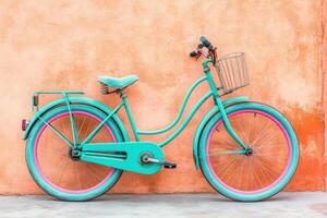 Teal bicycle against coral wall photo