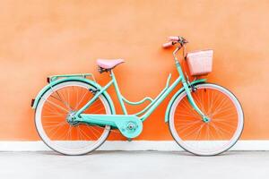 Pastel Bicycle Against Orange Wall photo