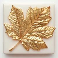 Gold leaf maple leaf on cream background photo