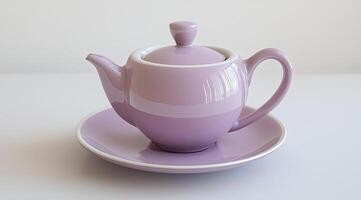 Elegant, lavender-colored teapot and saucer photo