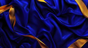 Luxurious deep blue silk draped with golden ribbons photo