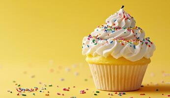 Birthday cupcake with white frosting and sprinkles photo