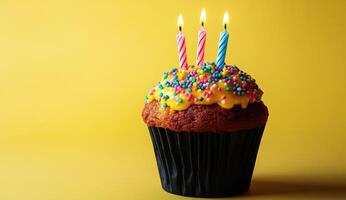 Birthday cupcake with three lit candles photo
