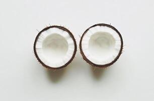 Two halved coconuts, crisp white flesh visible photo