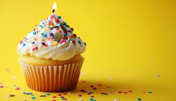 Birthday cupcake with a lit candle photo