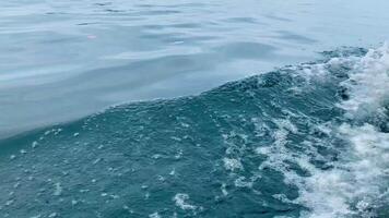 A boat is moving, making small waves from the front of the ship. video