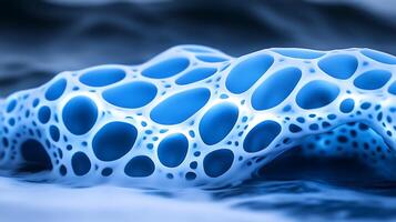 Blue Organic Structure with Abstract Honeycomb Patterns Floating on Fluid Surface photo