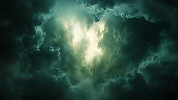 Dramatic Sky with Glowing Light Emerging Through Dark Clouds photo