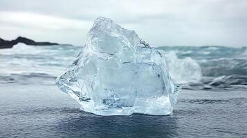 Crystal Iceberg on Black Sand Beach with Ocean Waves in Background photo