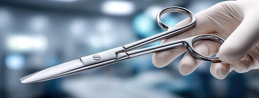 A person holding a pair of surgical scissors photo