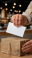 A person putting a blank card into a wooden box photo