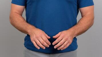 A man in a blue shirt is holding his hands together photo