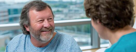 A man in a hospital room talking to another man photo