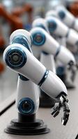 A row of robotic arms in a factory photo