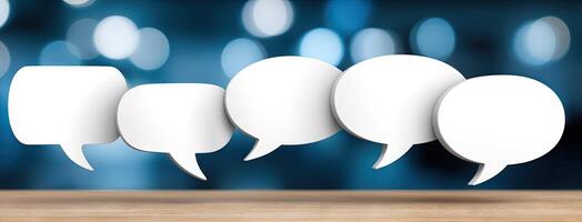 Four speech bubbles on a wooden table photo