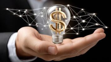 Businessman holding light bulb with dollar sign on it photo