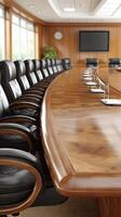 A conference table with black chairs and a large screen photo