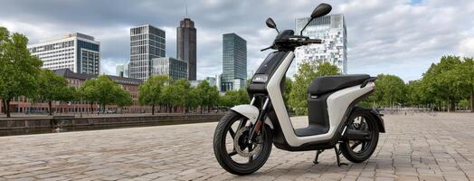 A white and black electric scooter parked on a brick road photo