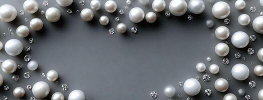 Pearls and diamonds in a heart shape on a gray background photo