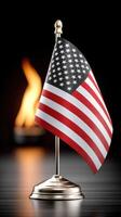 American flag on a metal stand with a flame in the background photo