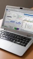 A laptop computer with graphs and charts on it photo