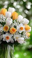 A vase filled with white and yellow flowers photo