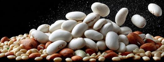 A pile of beans and nuts on a black background photo