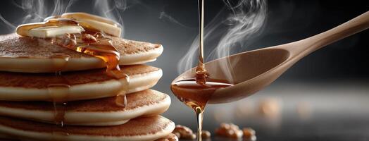 Pancakes with syrup and syrup on top photo