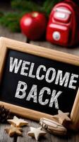 Welcome back sign on wooden background photo
