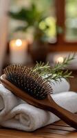 A wooden hairbrush and a towel on a table photo